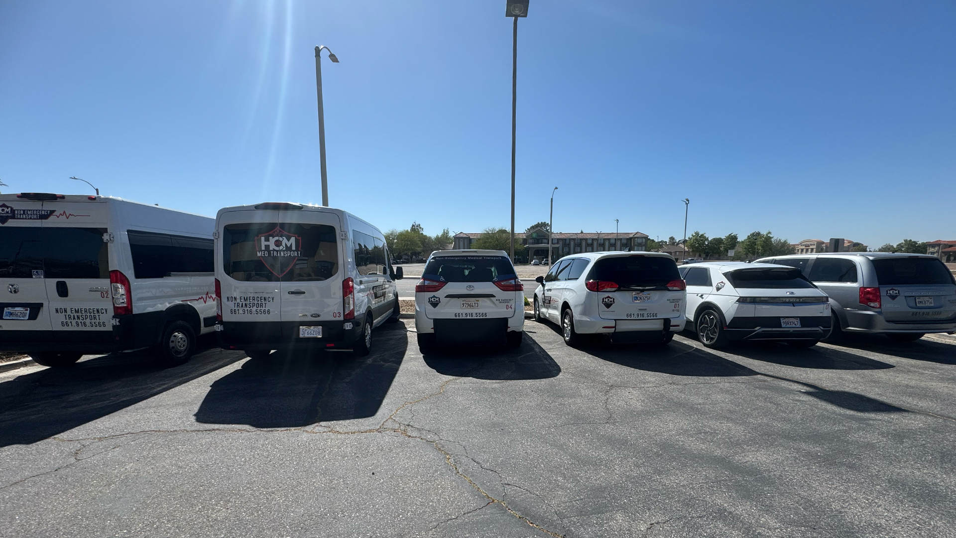 The HCM Med Transport fleet of vans parked outside the Lancaster office.